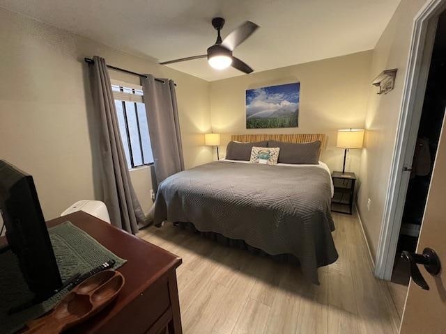 bedroom with light hardwood / wood-style floors and ceiling fan