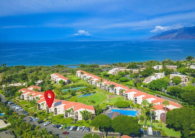 birds eye view of property with a water view