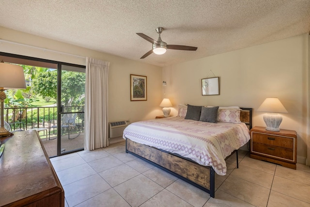 tiled bedroom featuring an AC wall unit, ceiling fan, access to outside, and a textured ceiling