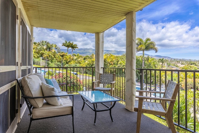 balcony with a sunroom and a mountain view