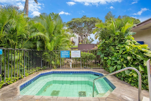 view of swimming pool featuring fence