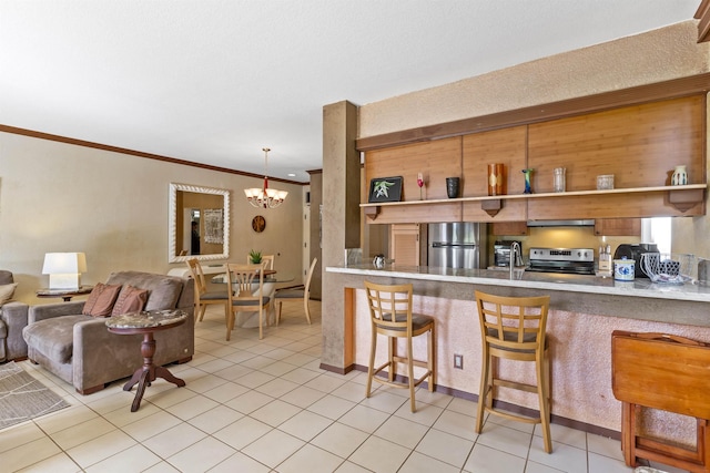 kitchen with pendant lighting, light tile patterned floors, a chandelier, and appliances with stainless steel finishes