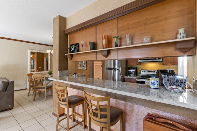 kitchen with kitchen peninsula, appliances with stainless steel finishes, ornamental molding, ventilation hood, and light tile patterned floors