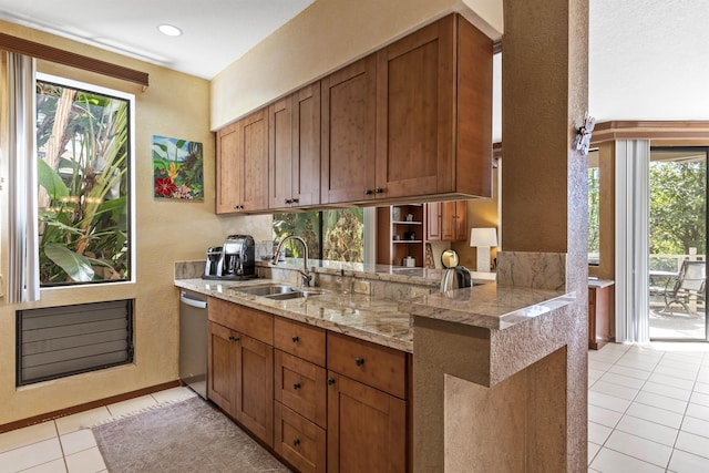 kitchen with kitchen peninsula, dishwasher, sink, and plenty of natural light