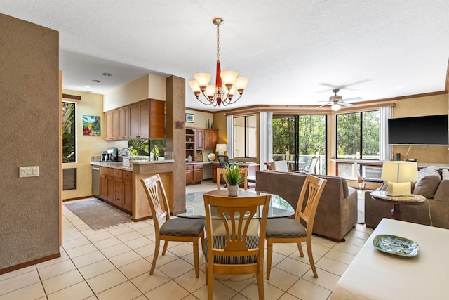 tiled dining room with a textured ceiling, crown molding, and ceiling fan with notable chandelier