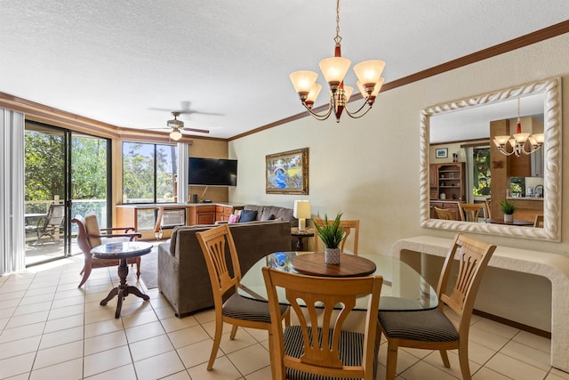 tiled dining area with a textured ceiling, ceiling fan with notable chandelier, and ornamental molding