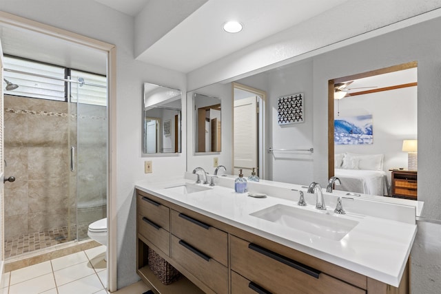 bathroom featuring tile patterned floors, vanity, toilet, and walk in shower