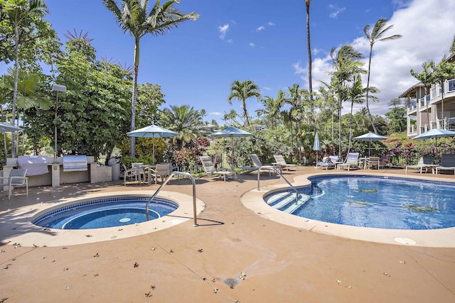 view of pool featuring a grill, a patio, and a hot tub