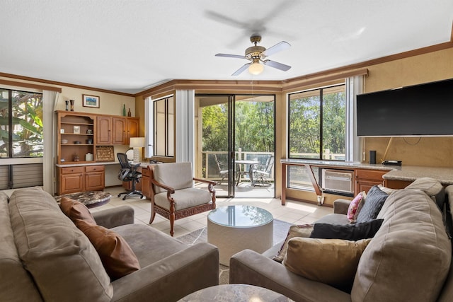 living room featuring ceiling fan, light tile patterned flooring, ornamental molding, and a wall unit AC