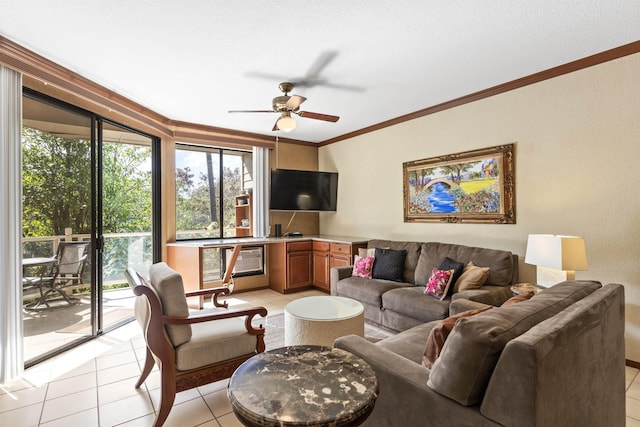 living room with light tile patterned floors, plenty of natural light, crown molding, and ceiling fan