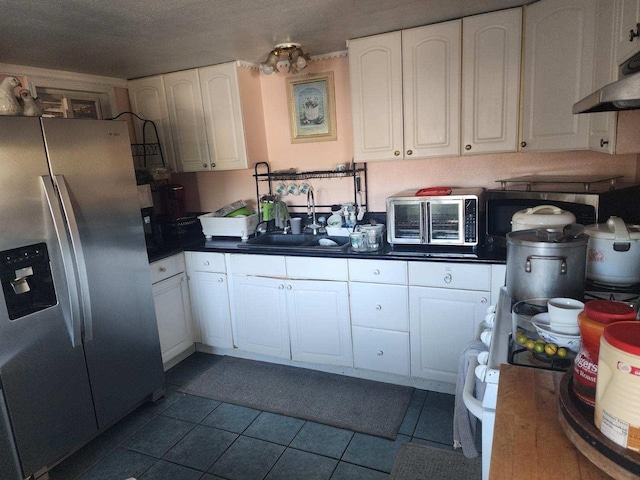 kitchen with stainless steel fridge with ice dispenser, sink, white cabinets, and light tile patterned flooring