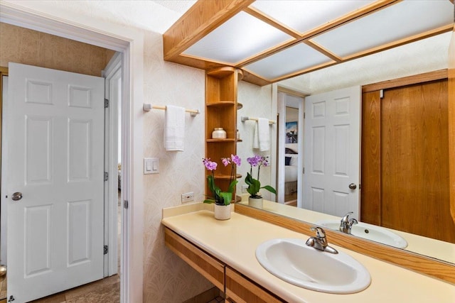 bathroom featuring vanity, wallpapered walls, and tile patterned floors