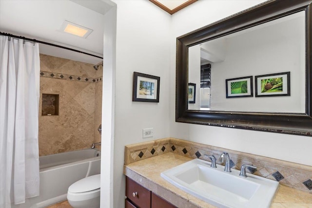 bathroom featuring toilet, vanity, and shower / bath combination with curtain