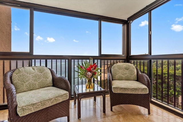 sunroom / solarium with a water view