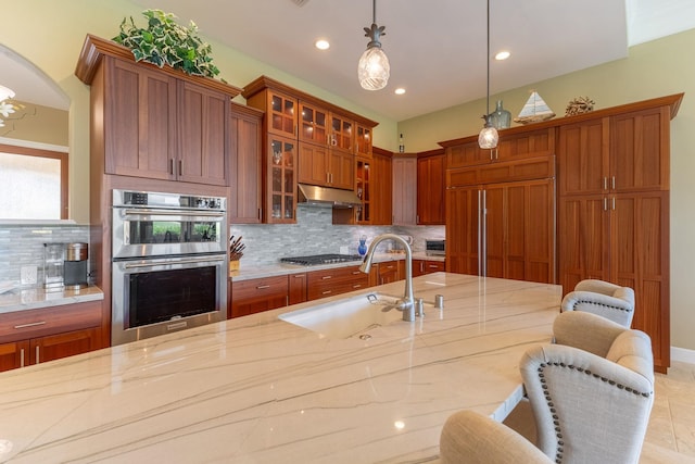 2563 Umeke Cir Unit 64, Kihei, HI 96753 - kitchen featuring stainless steel appliances, a sink, light stone counters, decorative light fixtures, and recessed lighting