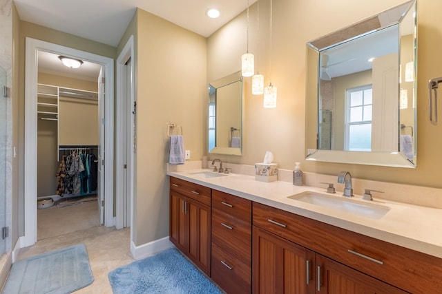 2563 Umeke Cir Unit 64, Kihei, HI 96753 - bathroom featuring double vanity, a spacious closet, and baseboards