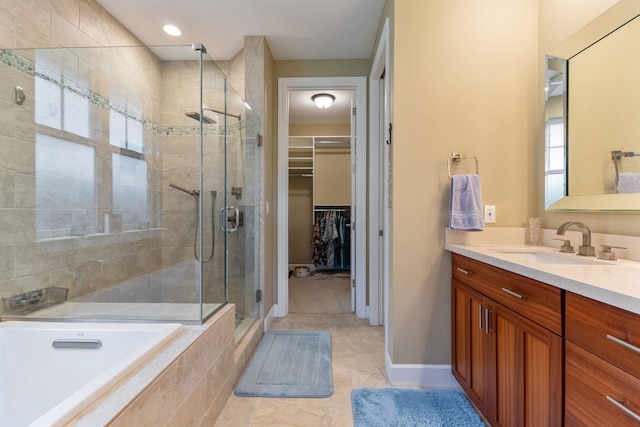 2563 Umeke Cir Unit 64, Kihei, HI 96753 - full bath featuring a stall shower, a bath, vanity, a spacious closet, and tile patterned floors