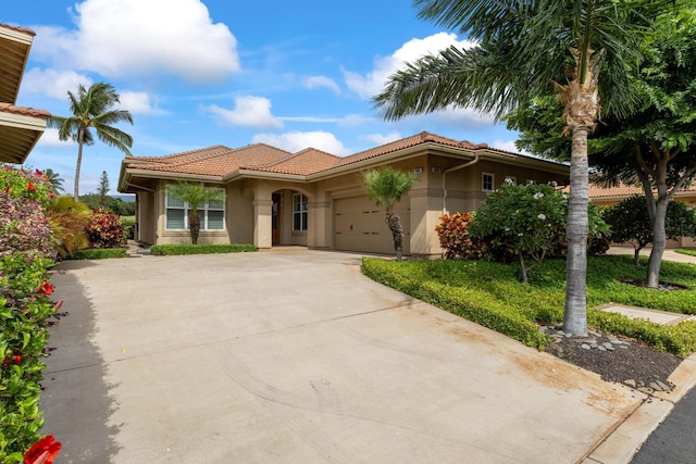 2563 Umeke Cir Unit 64, Kihei, HI 96753 - mediterranean / spanish house featuring a tiled roof, a garage, and stucco siding