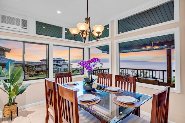 dining room with baseboards, a notable chandelier, tile patterned floors, and a wealth of natural light