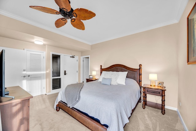 bedroom featuring light colored carpet, ornamental molding, baseboards, and ceiling fan
