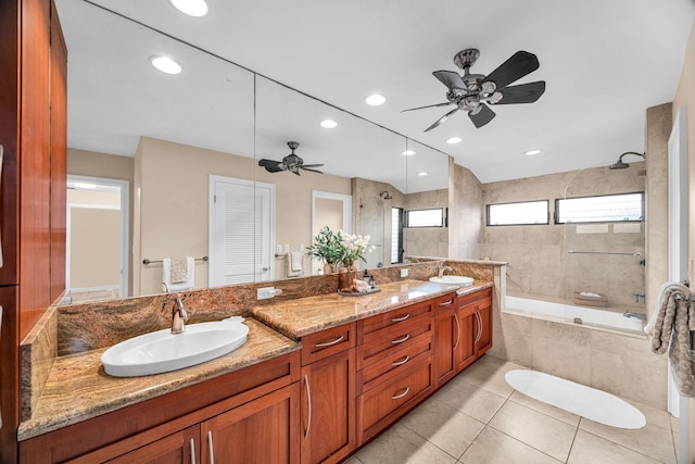 full bath featuring a sink, tiled shower / bath, a ceiling fan, and double vanity