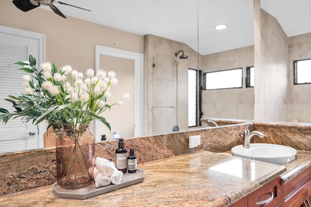 bathroom with ceiling fan, a shower, and vanity