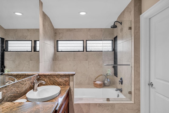 full bathroom with tiled shower / bath and vanity