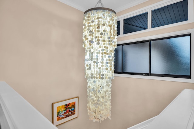 bathroom with crown molding and an inviting chandelier