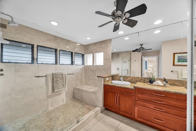 full bathroom with ceiling fan, a tile shower, vanity, tile patterned floors, and recessed lighting