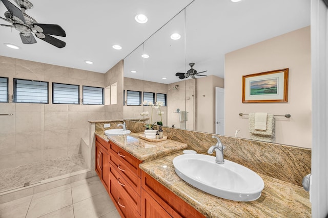 bathroom with a walk in shower, a ceiling fan, and a sink