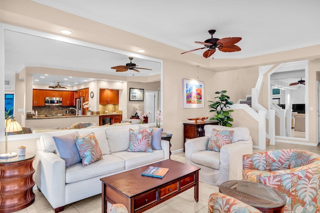 living area featuring crown molding, ceiling fan, recessed lighting, a raised ceiling, and light tile patterned floors
