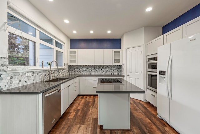 kitchen with white cabinetry, a center island, and appliances with stainless steel finishes