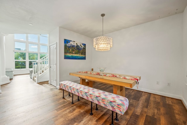 dining space featuring dark hardwood / wood-style flooring and a chandelier