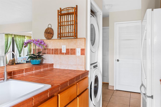 50 Kepuhi Pl Unit 128, Maunaloa, HI 96770 - laundry area featuring a sink, stacked washer / drying machine, light tile patterned flooring, and laundry area