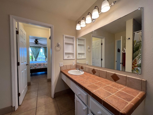 bathroom with tile patterned floors, vanity, and ceiling fan