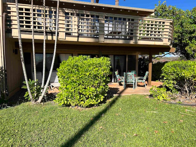 rear view of property with a yard and a patio area