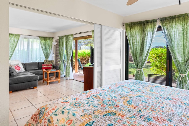50 Kepuhi Pl Unit 128, Maunaloa, HI 96770 - bedroom featuring tile patterned floors, access to outside, a ceiling fan, and multiple windows