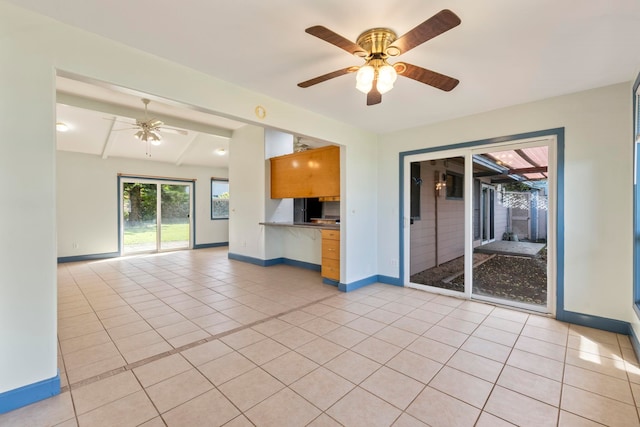 unfurnished living room with ceiling fan and light tile patterned floors