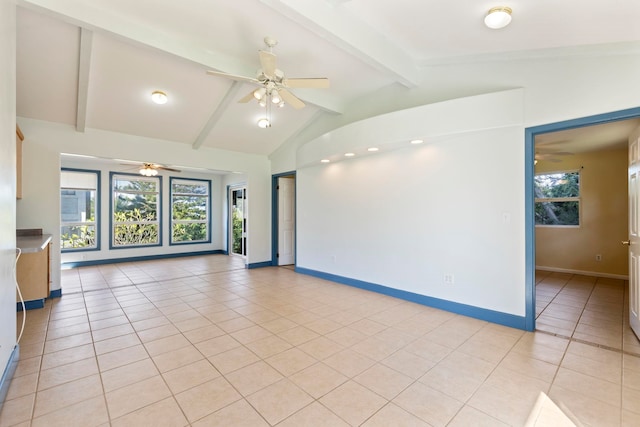 tiled spare room featuring vaulted ceiling with beams and ceiling fan