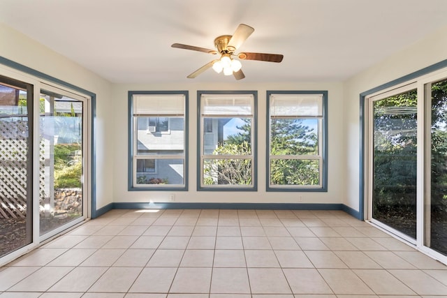 unfurnished sunroom with ceiling fan and a wealth of natural light