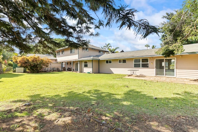 rear view of house with a yard