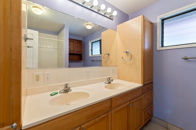 bathroom with walk in shower, tile patterned floors, and vanity