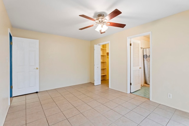 empty room with light tile patterned floors and ceiling fan