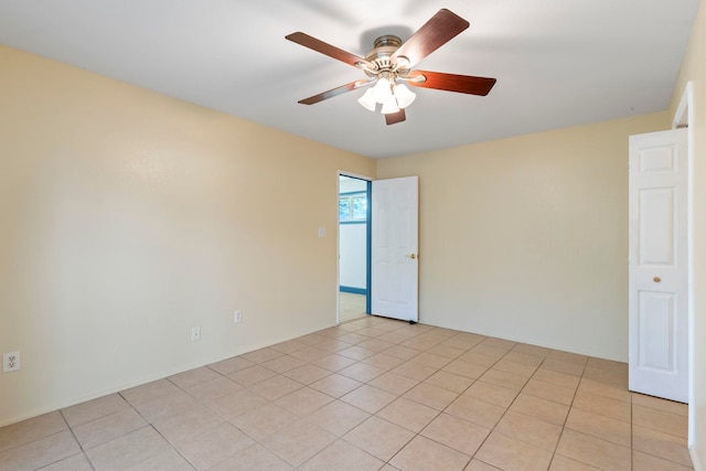 tiled empty room with ceiling fan