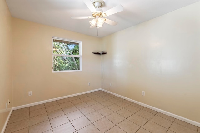 spare room with ceiling fan and light tile patterned floors