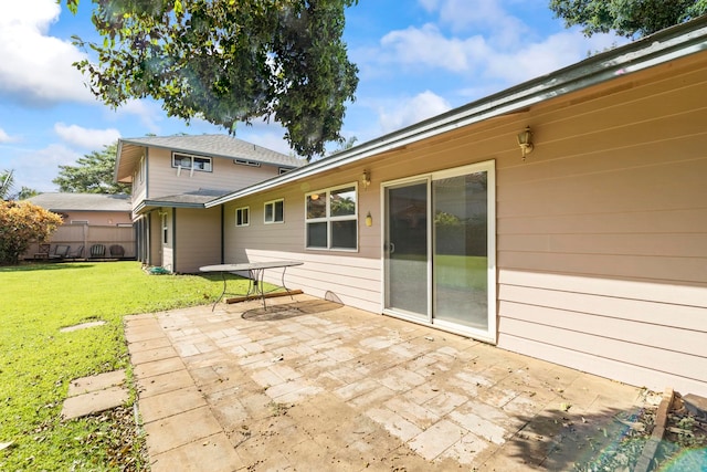 rear view of property with a patio area and a yard