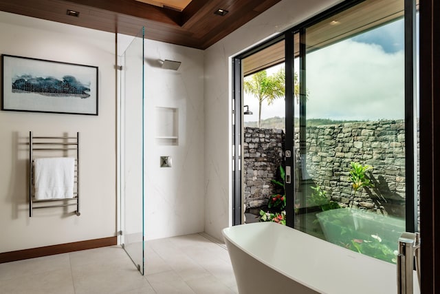 210 Naio Pl, Lahaina, HI 96761 - bathroom with radiator heating unit, a soaking tub, tile patterned flooring, and a towel warmer