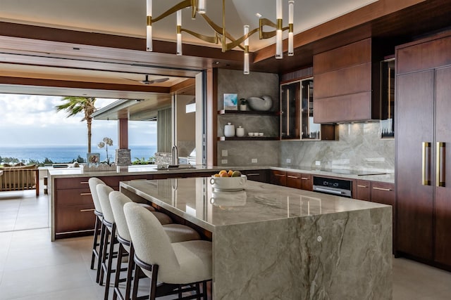 210 Naio Pl, Lahaina, HI 96761 - kitchen featuring paneled built in fridge, modern cabinets, backsplash, and a center island