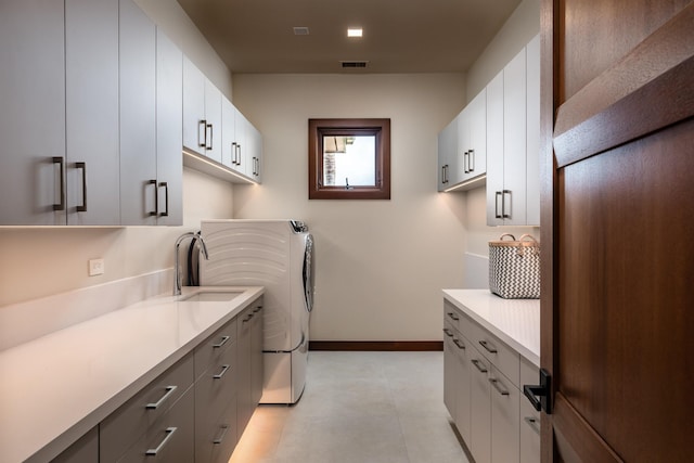 210 Naio Pl, Lahaina, HI 96761 - laundry area with cabinet space, washer and clothes dryer, and baseboards