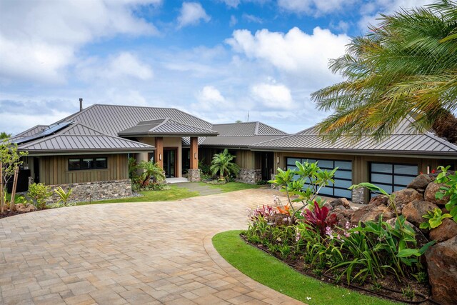 210 Naio Pl, Lahaina, HI 96761 - view of front of property featuring curved driveway, board and batten siding, metal roof, and stone siding